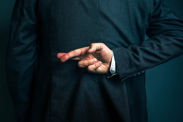 Business man holding fingers behind his back