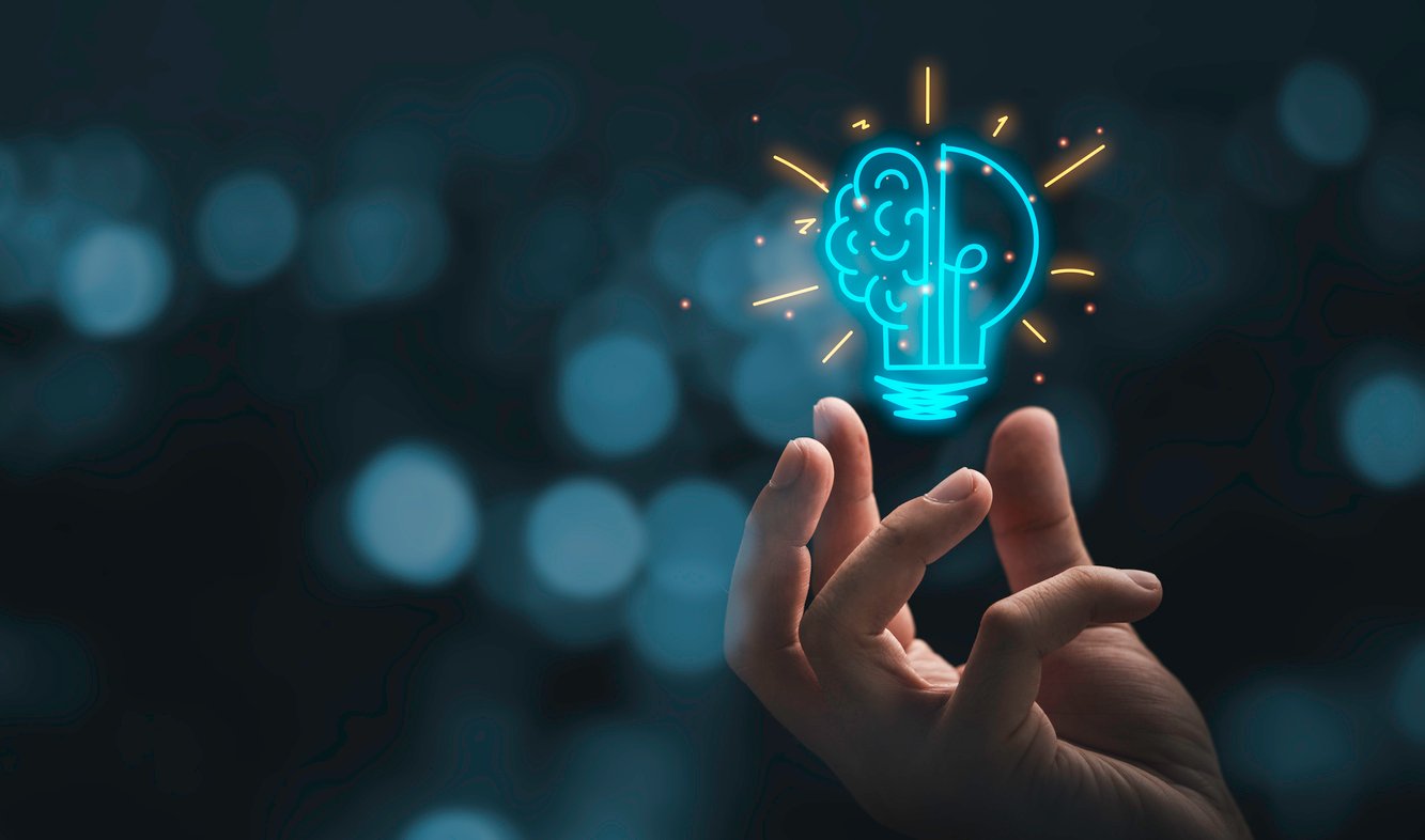 innovative concept lightbulb hovering over hand
